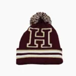 a red beanie with a letter on it