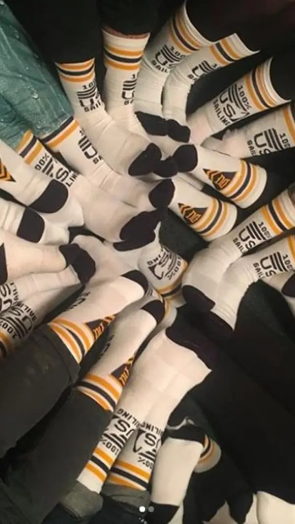 Student feet in circle showing off custom socks