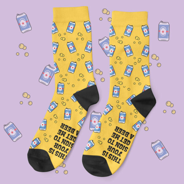 a pair of yellow socks with beer cans on them