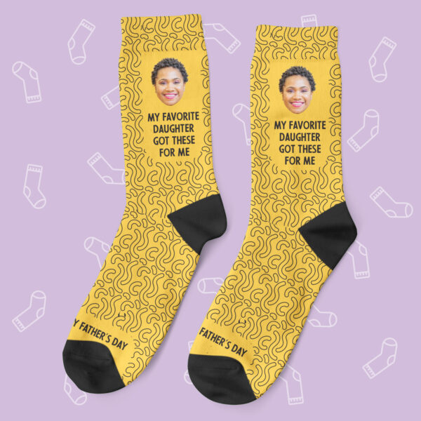 a pair of yellow socks with a photo of a woman's face