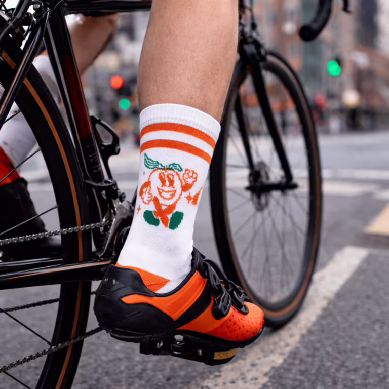 A professional product shot of a pair of custom-designed cycling crew socks, highlighting their athletic fit and performance fabric.